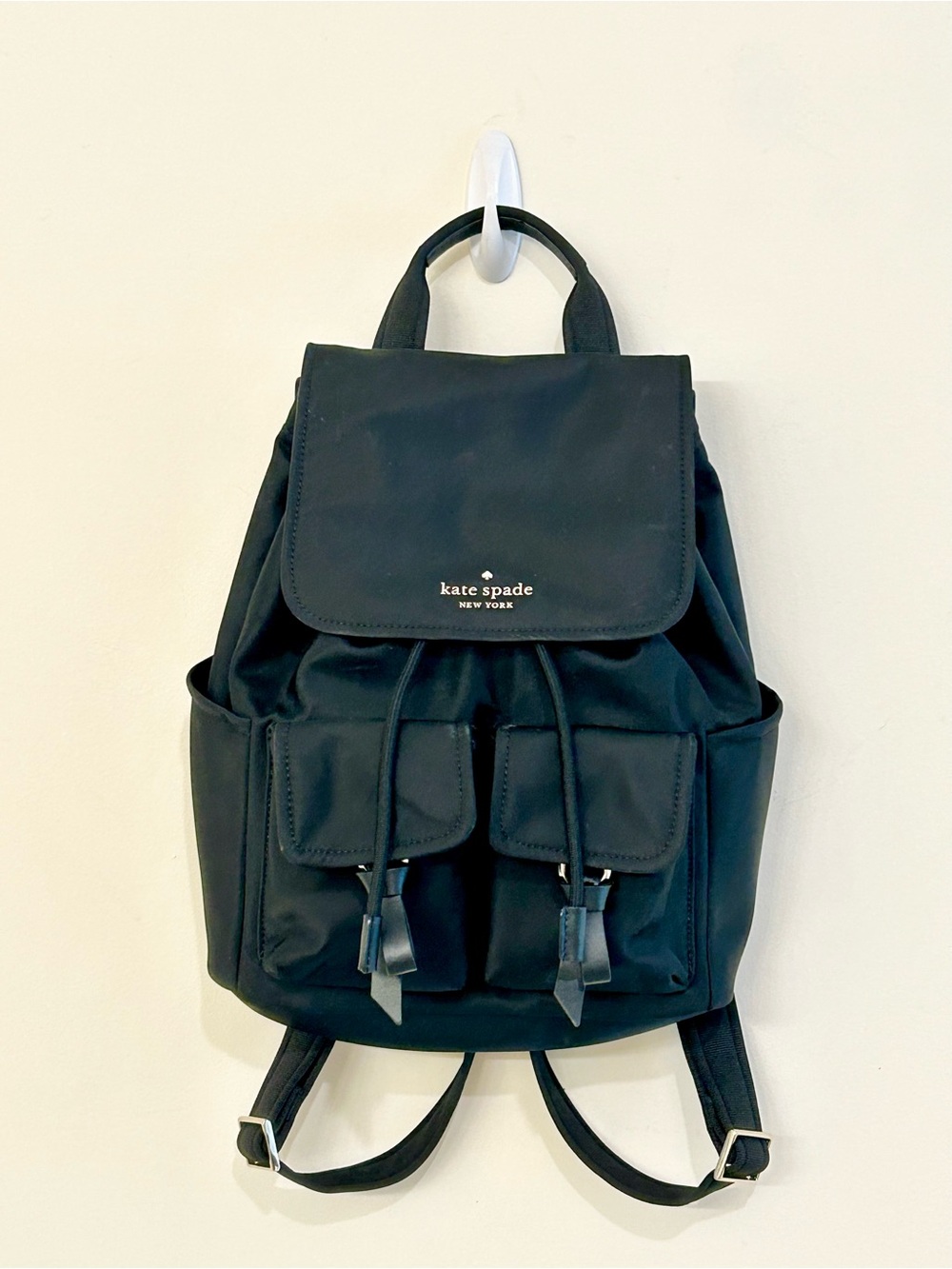 Kate Spade New York Carly Flap Drawstring Backpack in Black Technical Nylon